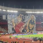 Here are some alternate titles for "Koreografi Berhias Tifo Pendekar Wayang Warnai Laga Indonesia vs China":

1. "Tifo Pendekar: Koreografi Memukau dalam Laga Indonesia vs China"
2. "Harmoni Tifo: Menyemarakkan Pertandingan Indonesia vs China"
3. "Semangat Wayang: Koreografi Tifo di Pertandingan Indonesia vs China"
4. "Pesona Tifo Pendekar: Warna dan Gerakan dalam Duel Indonesia vs China"
5. "Kreativitas Tifo: Menghidupkan Suasana Laga Indonesia vs China"
6. "Pentas Seni Tifo: Memperindah Pertarungan Indonesia dan China"
7. "Gema Budaya: Koreografi Tifo Pendekar dalam Laga Indonesia vs China"
8. "Tari Tifo: Menghiasi Pertandingan Seru Indonesia vs China"
9. "Keajaiban Budaya: Tifo Pendekar dalam Aksi Indonesia vs China"
10. "Warisan Seni: Koreografi Tifo yang Memikat dalam Pertandingan Indonesia vs China"

Feel free to mix and match or modify these suggestions!